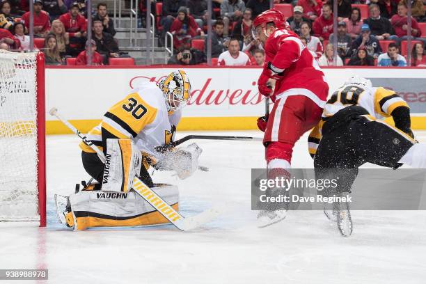 Matt Murray of the Pittsburgh Penguins makes a save on Luke Glendening of the Detroit Red Wings during an NHL game at Little Caesars Arena on March...