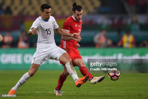 Gareth Bale, right, of Wales national football team kicks the ball to make a pass against Matias Vecino of Uruguay national football team in their...