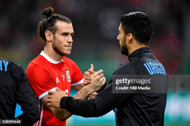 Gareth Bale, left, of Wales national football team shakes hands with Luis Suarez of Uruguay national football team in their final match during the...