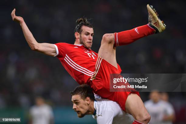 Player of Uruguay national football team challenges Gareth Bale, top, of Wales national football team in their final match during the 2018 Gree China...