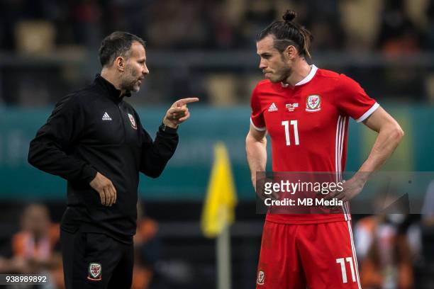 Head coach Ryan Giggs, left, of Wales national football team instrucs his player Gareth Bale as they compete against Uruguay national football team...