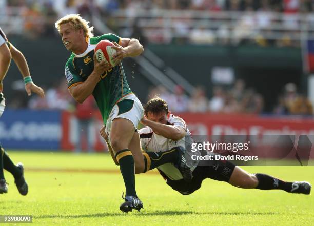 Kyle Brown of South Africa makes a break during the game against the Arabian Gulf during the IRB Sevens tournament at the Dubai Sevens Stadium on...