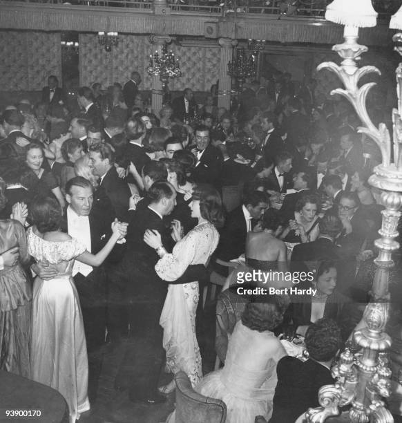 Busy evening at the Cafe de Paris nightclub in London, after a theatre first-night, February 1951. Original publication: Picture Post - 5202 -...