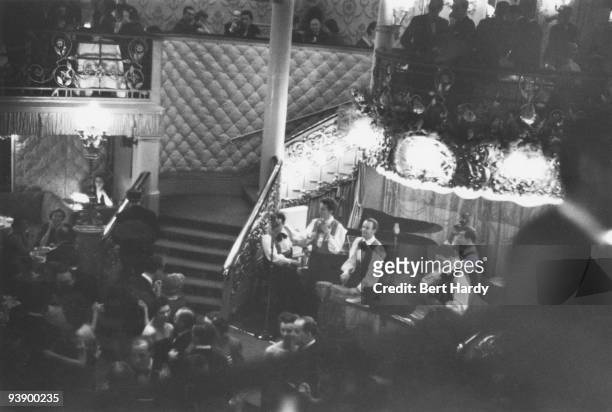 John Kerrison's rhumba-style band plays on a busy evening at the Cafe de Paris nightclub in London, February 1951. Original publication: Picture Post...