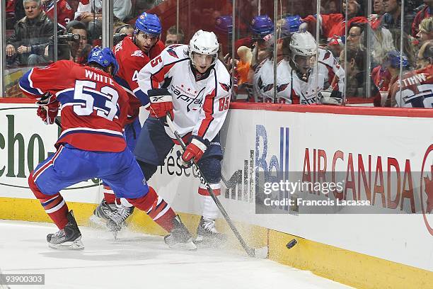 Ryan White of the Montreal Canadiens battles for the puck along the boardside with Mathieu Perreault of Washington Capitals during the NHL game on...