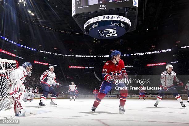 John Erskine of Washington Capitals and teammate Mike Green and Ryan White of the Montreal Canadiens look at the action during the NHL game on...