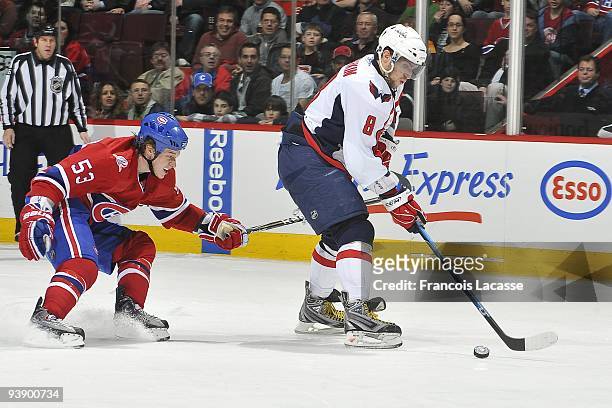 Alex Ovechkin of Washington Capitals skates with the puck in front of Ryan White of the Montreal Canadiens during the NHL game on November 28, 2009...