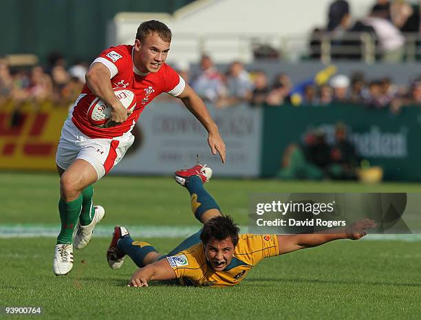 Chris Morgan of Wales moves away from Nick Phipps of Australia during the IRB Sevens tournament at the Dubai Sevens Stadium on December 4, 2009 in...