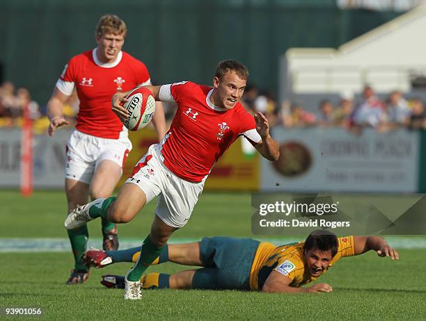 Chris Morgan of Wales moves away from Nick Phipps of Australia during the IRB Sevens tournament at the Dubai Sevens Stadium on December 4, 2009 in...