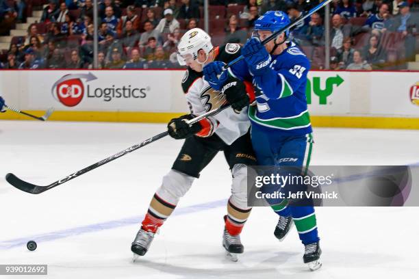 Henrik Sedin of the Vancouver Canucks checks Chris Kelly of the Anaheim Ducks during their NHL game at Rogers Arena March 27, 2018 in Vancouver,...