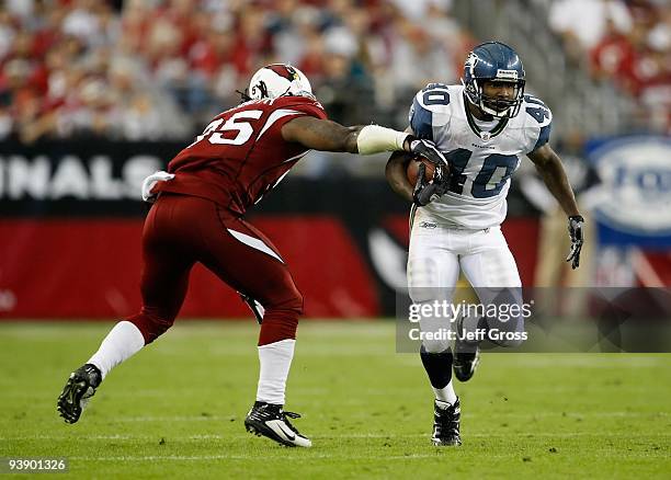 Louis Rankin of the Seattle Seahawks carries the ball while being pursued by Ali Highsmith of the Arizona Cardinals at University of Phoenix Stadium...