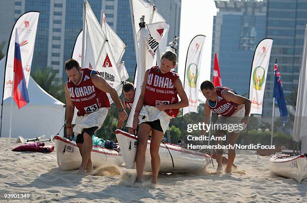 Team Abu Dhabi Valcons of United Kingdom carries the boats to the water at the start of the kajak section of stage one on December 4, 2009 in Abu...