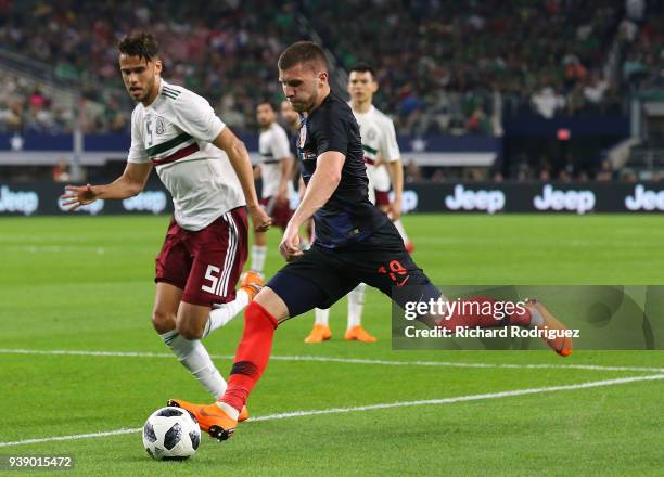 Diego Reyes of Mexico challenges Ante Rebic of Croatia as he attempts a shot on goal in the first half of an internationial friendly soccer match at...
