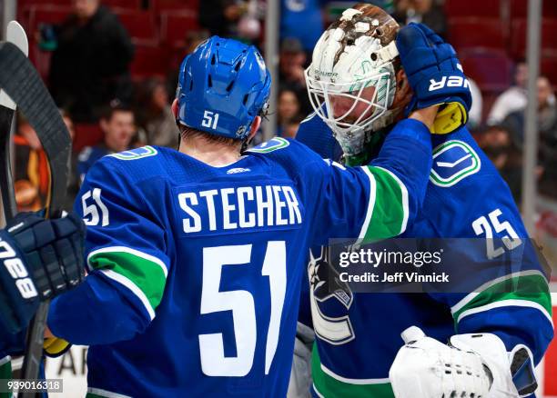 Jacob Markstrom of the Vancouver Canucks congratulates teammate Troy Stecher after their NHL game against the Anaheim Ducks at Rogers Arena March 27,...