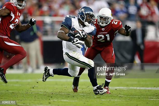 Justin Forsett of the Seattle Seahawks carries the ball while being pursued by Antrel Rolle of the Arizona Cardinals at University of Phoenix Stadium...