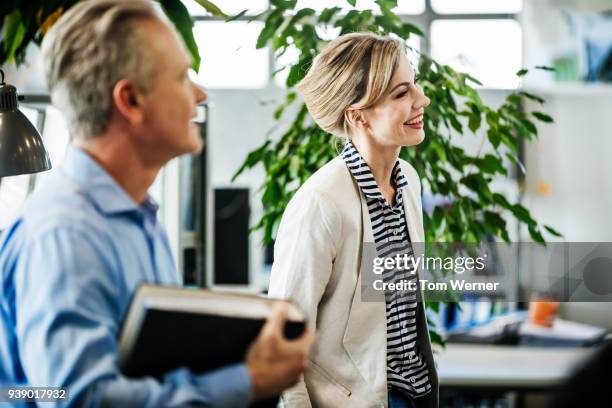 business colleagues smiling during meeting - agenda meeting stock pictures, royalty-free photos & images