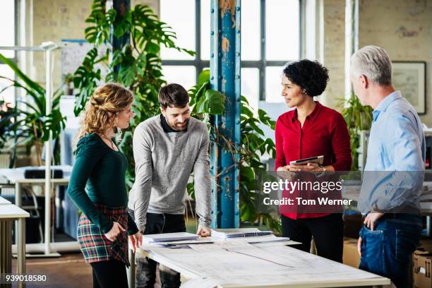 office team having meeting together - green dress shirt stock pictures, royalty-free photos & images
