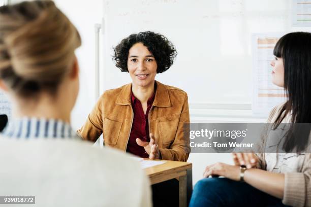 co-workers presenting sales pitch to business mananger - group of man woman at the meeting stock-fotos und bilder