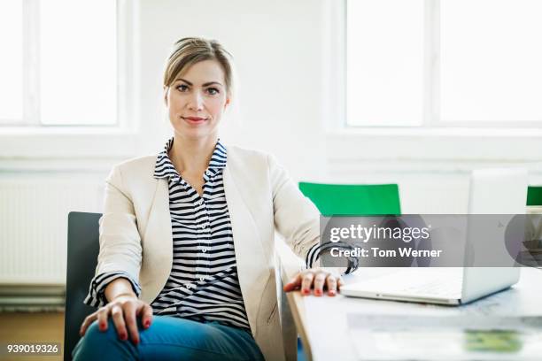 portrait of business owner at conference table - white blazer stock pictures, royalty-free photos & images
