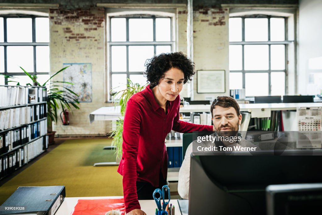 Office Manager Assisting Employee With Problem