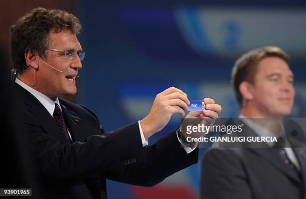 Secretary General Jerome Valcke holds up the French ticket during the World Cup 2010 draw at the Cape Town International Convention Centre in Cape...
