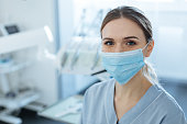 Charming female dentist posing in a face mask