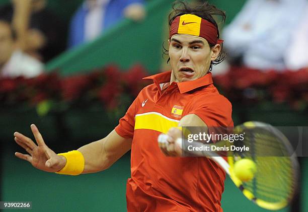 Rafael Nadal of Spain returns a shotn to Tomas Berdych of Czech Republic during the first match of the Davis Cup final at the Palau Sant Jordi...