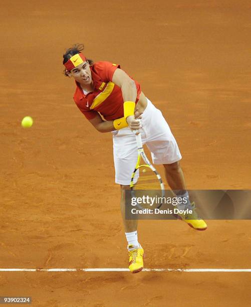 Rafael Nadal of Spain serves to Tomas Berdych of Czech Republic during the first match of the Davis Cup final at the Palau Sant Jordi stadium on...