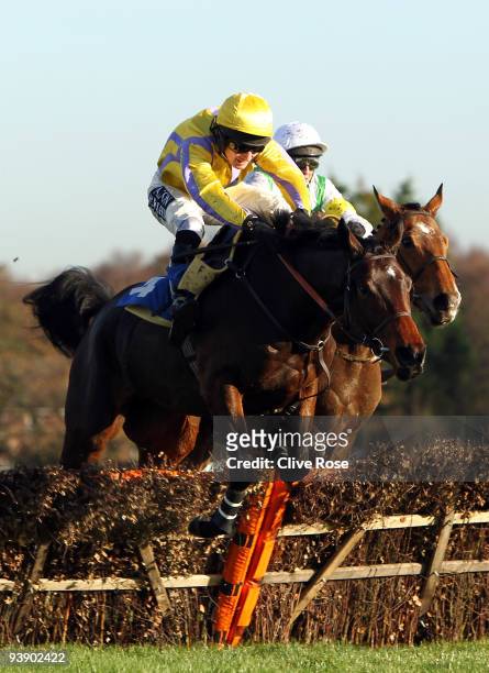 Spunk ridden by Dougie Costello leads over the last to win the Formulawine.co.uk Juvenile Novices' Hurdle run at Sandown Park on December 4, 2009 in...