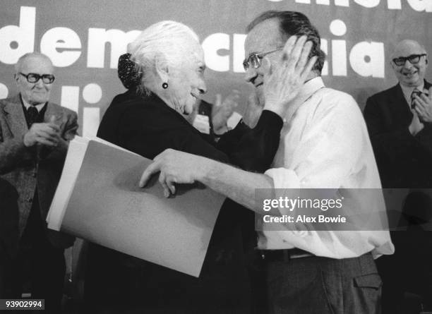 Spanish politician Dolores Ibarruri Gomez , known as 'La Pasionaria', congratulates Communist Party General-Secretary Santiago Carrillo on his speech...