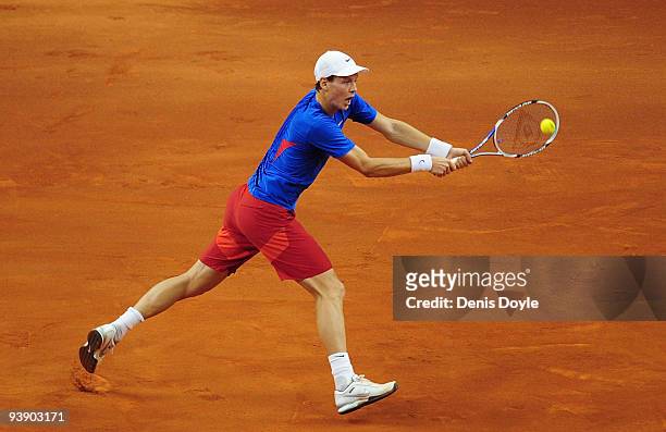 Tomas Berdych of Czech Republic returns the ball to Rafael Nadal of Spain during the first match of the Davis Cup final at the Palau Sant Jordi...