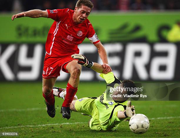 Andreas Lambertz of Duesseldorf passes by Dennis Eilhoff of Bielefeld during the Second Bundesliga match between Fortuna Duesseldorf and Arminia...