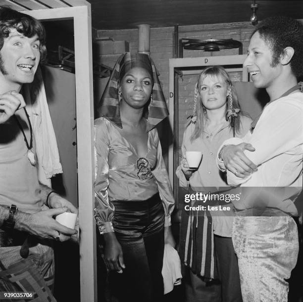 American singer-songwriter, musician and activist Nina Simone backstage with the cast of rock musical 'Hair', Uk, 4th December 1968.