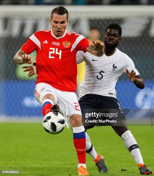 Anton Zabolotny of Russia national team and Samuel Umtiti of France national team vie for the ball during the international friendly football match...