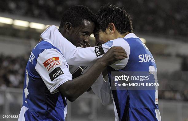 Porto´s forward Silvestre Varela celebrates with teammate defender Jorge Fucile from Uruguay after scoring against Vitoria SC during their Portuguese...