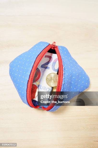 high angle view of a purse full of euro coins and twenty euro banknote - full wallet stock pictures, royalty-free photos & images