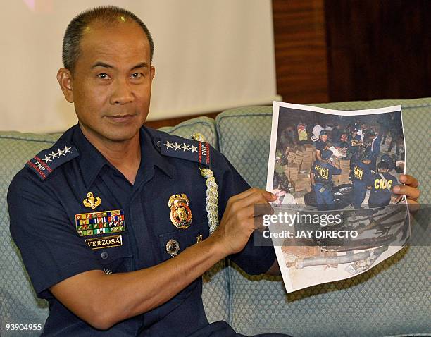 Philippine National Police Chief Jesus Verzosa holds a photo of operations conducted in Shariff Aguak, Maguindanao, southern Philippines, following...