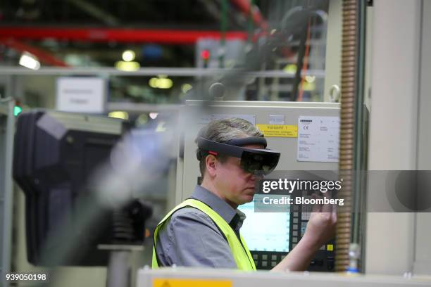 An employee wears a pair of Hololens 3D glasses during an Industry 4.0 presentation at the ZF Friedrichshafen AG automobile component factory in...