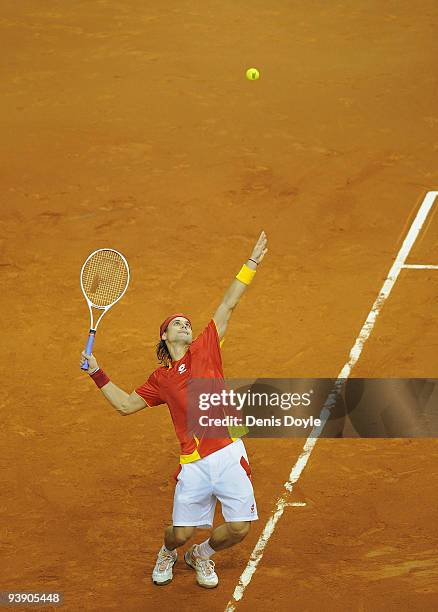 David Ferrer of Spain serves against Radek Stepanek of Czech Republic during the second match of the Davis Cup final at the Palau Sant Jordi stadium...