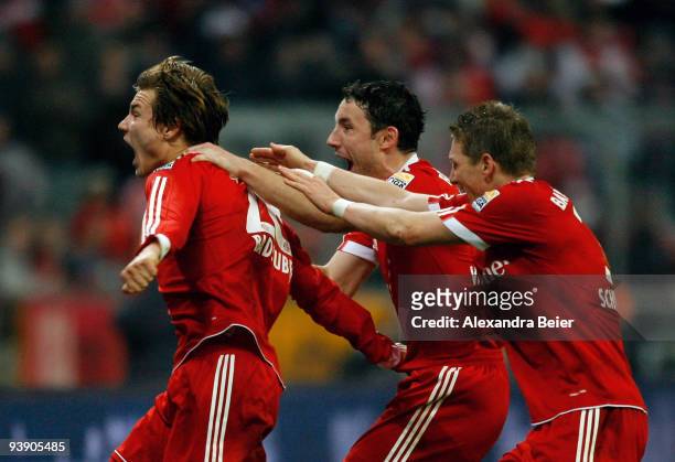 Holger Badstuber, Marc van Bommel and Bastian Schweinsteiger of Bayern Muenchen celebrate Badstuber's goal during the Bundesliga match between FC...