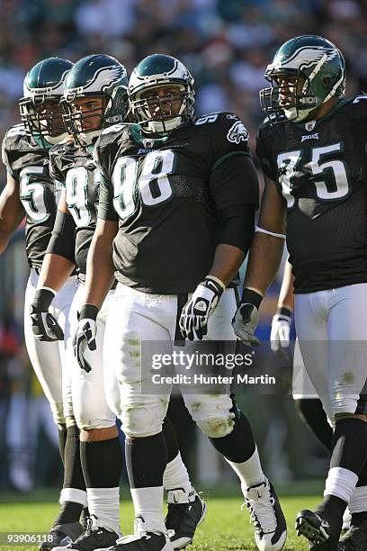 Defensive tackle Mike Patterson of the Philadelphia Eagles walks off the field with defensive end Trent Cole, defensive tackle Trevor Laws, and...