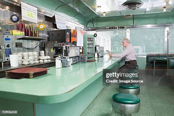 old man sitting in a diner - usa diner stock pictures, royalty-free photos & images