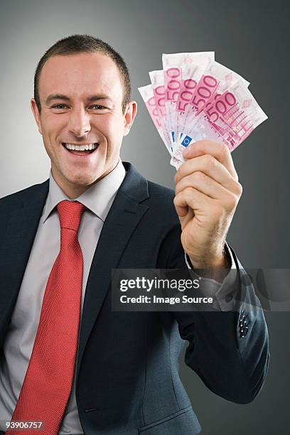 smiling businessman with bank notes - five hundred euro banknote stock pictures, royalty-free photos & images