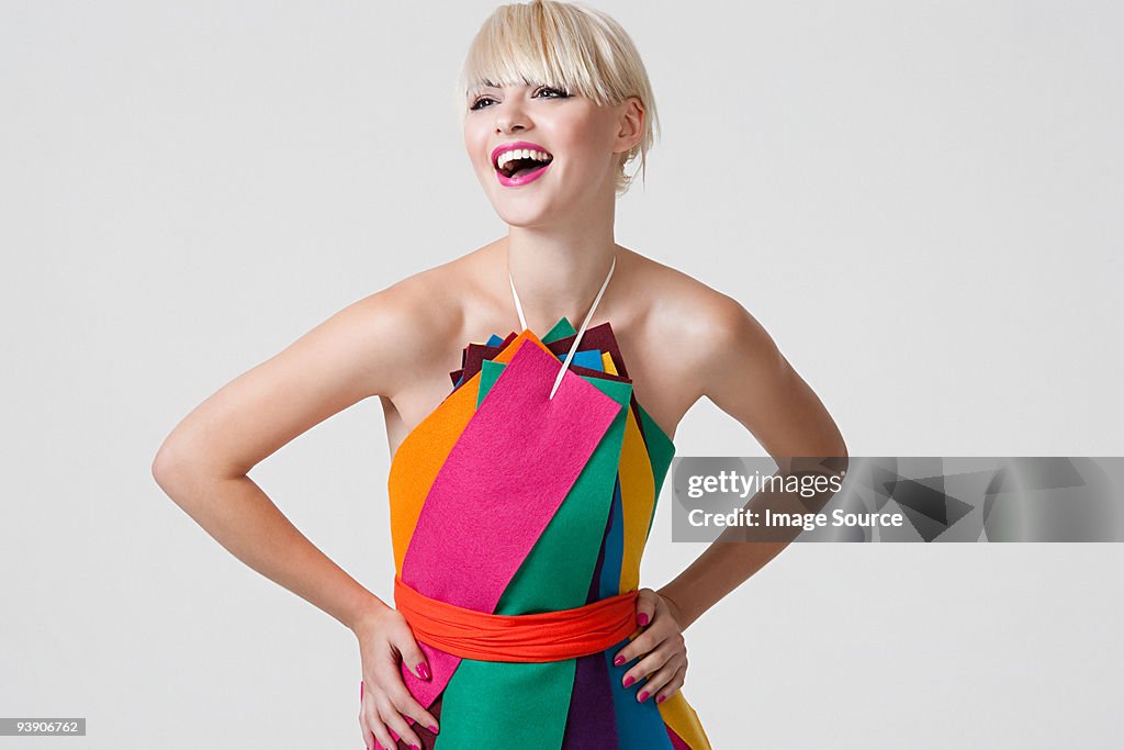 Young woman in dress made of coloured ribbons