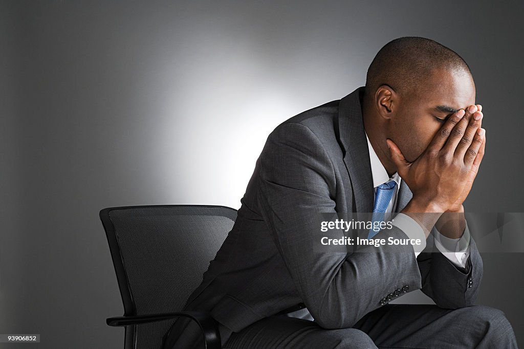 Businessman with head in hands