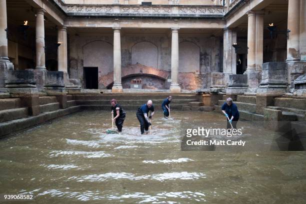 Bath and North East Somerset Council employees brush algae and sludge from the original Roman lead lined floor of the Great Bath as it is drained of...