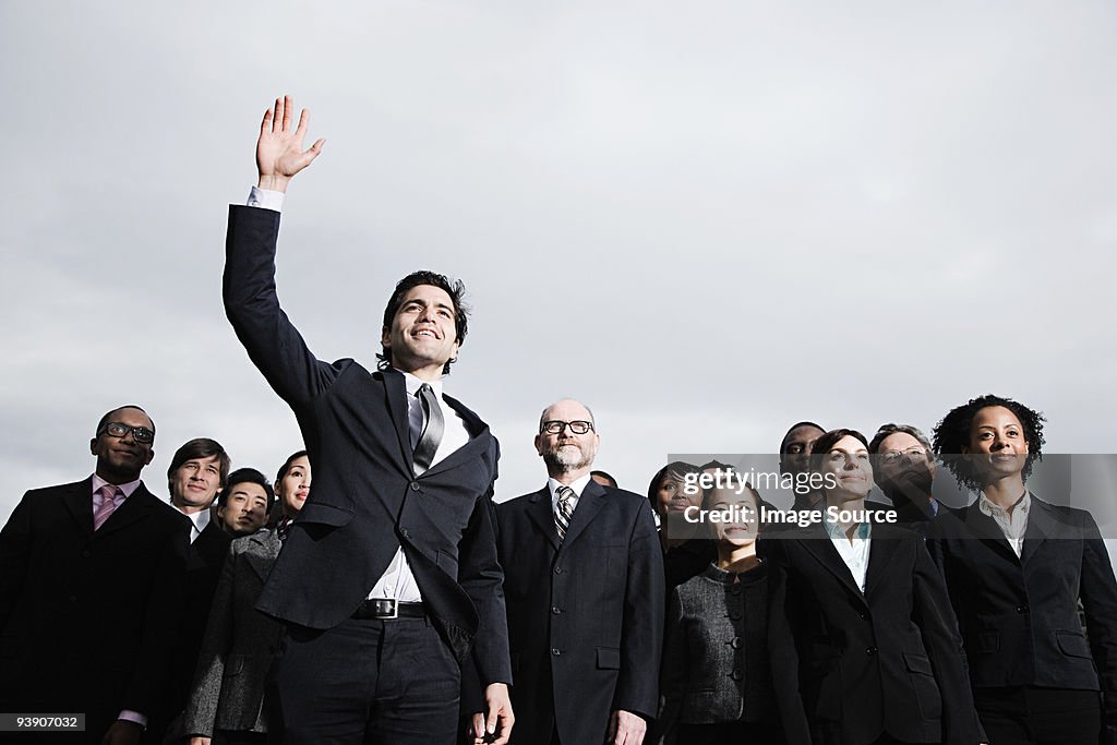 Businessman with arm raised