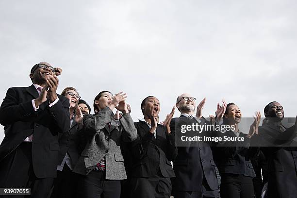 businesspeople clapping - group of businesspeople standing low angle view stock pictures, royalty-free photos & images