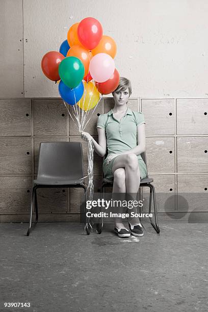 teenage girl holding bunch of balloons - isolated colour stockfoto's en -beelden