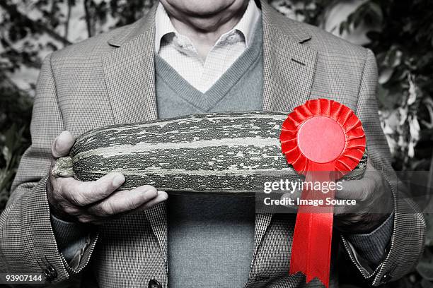 man holding winning marrow - black and white vegetables stock pictures, royalty-free photos & images